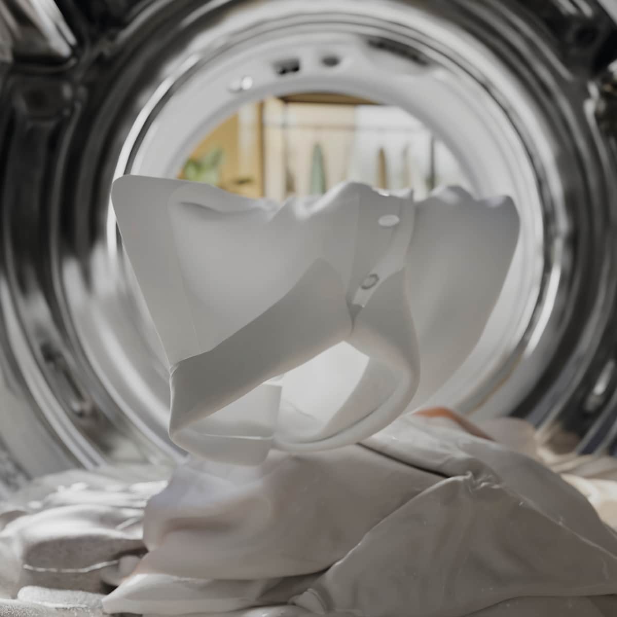 Miele vaskemaskine set indefra med hvidt vasketøj