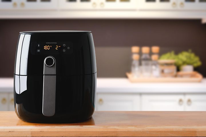 En sort airfryer på et køkkenbord