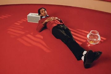 Man lying on a Marshall speaker