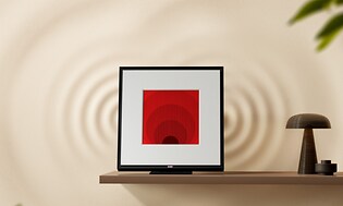Samsung Music Frame på væg ved siden af lampe